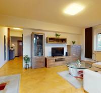 Living room in a two-room apartment with a wooden decor floor and comfortable furniture.