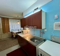 A kitchen with a light blue wall and a dining area in a 4-room apartment.