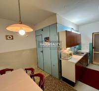 Kitchen in a 4-room apartment with a dining table and kitchen unit.