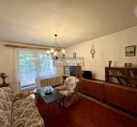 Living room with antique furniture, sofa, and chandeliers in a 4-room apartment.