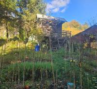 A cottage in Trenčianske Teplice on Sady pod Dedovcom street surrounded by a green garden.