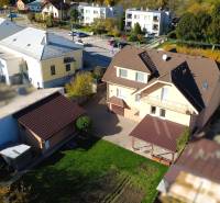 A family house in Bolešov with a balcony, garage, and landscaped yard.