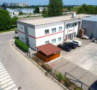 Commercial premises on Strojárenská Street in Trnava, with parking and surrounding buildings.