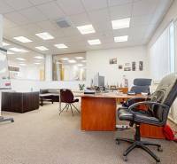 Commercial premises with furniture, office equipment, and white walls, floor with wood decor.