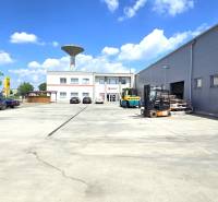 Commercial premises on Strojárenská Street in Trnava with parking and industrial equipment.