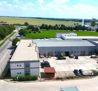 Commercial premises on Strojárenská Street in Trnava with an adjacent parking lot and surrounding greenery.