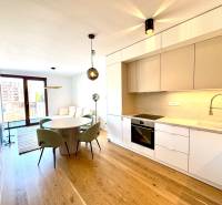 Kitchen unit, dining table, wooden decor flooring in a 2-room apartment.