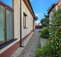 A view of the side of a family house on Štúrova Street in Vráble with a paved walkway.