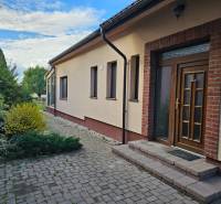 Family house on Štúrova Street in Vráble with brick cladding and garden landscaping.