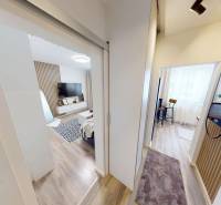 Interior of a 1-room apartment with a wooden decor floor and modern furnishings.