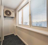 A narrow room with air conditioning and blinds in a 2-room apartment.