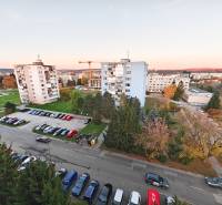 View from Považská Street in Košice - Západ district, panel buildings and greenery.
