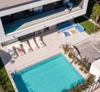 A villa in Bale with a pool, sun loungers, and comfortable outdoor seating.