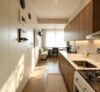 Cozy kitchen in a 3-room apartment with a wood-patterned floor and modern furnishings.