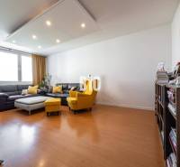 Living room in a 4-room apartment with a wooden decor floor and comfortable furniture.
