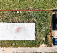 Plots in Čeľadice suitable for living, with a view of the neighboring building.