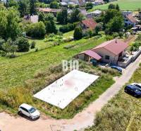Plots - housing in Čeľadice show a foundation slab between houses and greenery.