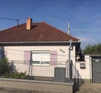 A family house in Čierna Voda with a white facade and a brick roof.