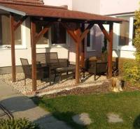 A family house in Čierna Voda with a terrace, garden furniture, and a green lawn.