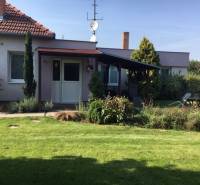A family house in Čierna Voda with a well-maintained garden and a covered terrace.