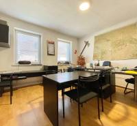 Office in a family house with a map on the wall and furniture for work and meetings.