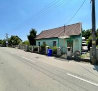 A family house on Záblatská Street in Trenčín, next to the road with a blue container.
