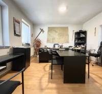 Office in a family house with dark furniture and a map on the wall.