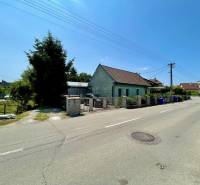 A family house on Záblatská Street in Trenčín, with garbage bins next to the fence.