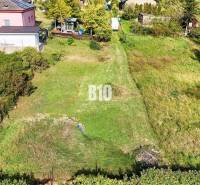 Plots - housing in Nitra with a landscaped garden and surrounding houses.