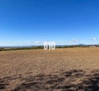 View of the fields behind Lackov, with hills on the horizon in the background.
