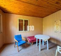 Wooden interior with an armchair, table, and painting, ideal for a vineyard.