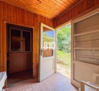 Wooden interior of a cottage with open doors to the garden, Vineyards.