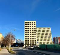 A building on Karpatská Street in Poprad with a view of the Tatras and a blue sky.