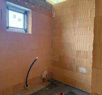 A construction room in a family house with brick walls and installation.