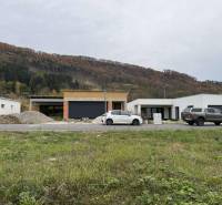 A family house on Na Kúty Street in Teplička nad Váhom with cars and wooded hills.