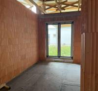 A building in a family house with brick walls and a French window.