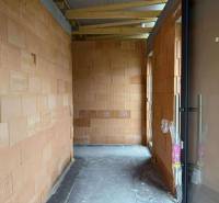 A building in a family house with brick walls and a concrete floor.
