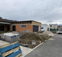 Construction of a family house on Na Kúty Street in Teplička nad Váhom with building materials in front of the house.
