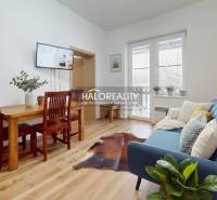 A kitchen unit with a marble decor and appliances in a 3-room apartment.