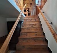 Interior of a family house with wooden stairs and paneling to the attic space.