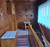 Interior of a family house with a wooden decor floor and traditional wall decorations.