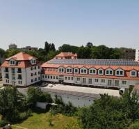 The building on Sadová Street in Senica with a red roof and solar panels.