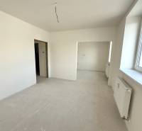 Bright room, spacious window, white walls, and a radiator in a 2-room apartment.