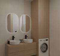 Bathroom with wooden furniture and two sinks, washing machine for laundry.