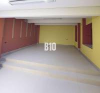 Commercial spaces with colorful walls and stairs, floor with a smooth surface.