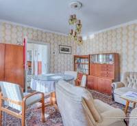 Living room in a family house with retro furniture and a wooden decor floor.