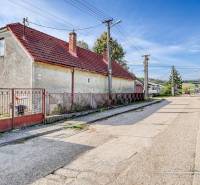 A family house on Dobrá Voda Street in Dobrá Voda, surrounded by greenery and a blue sky.