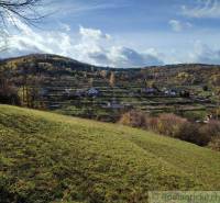 Hilly landscape with greenery and village houses in the gardens of Hlboké nad Váhom.