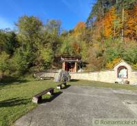 The gardens in Hlboké nad Váhom offer autumn colors of trees with a chapel and benches.