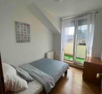 A bright room with a bed in a 3-room apartment, wall decoration with the alphabet.